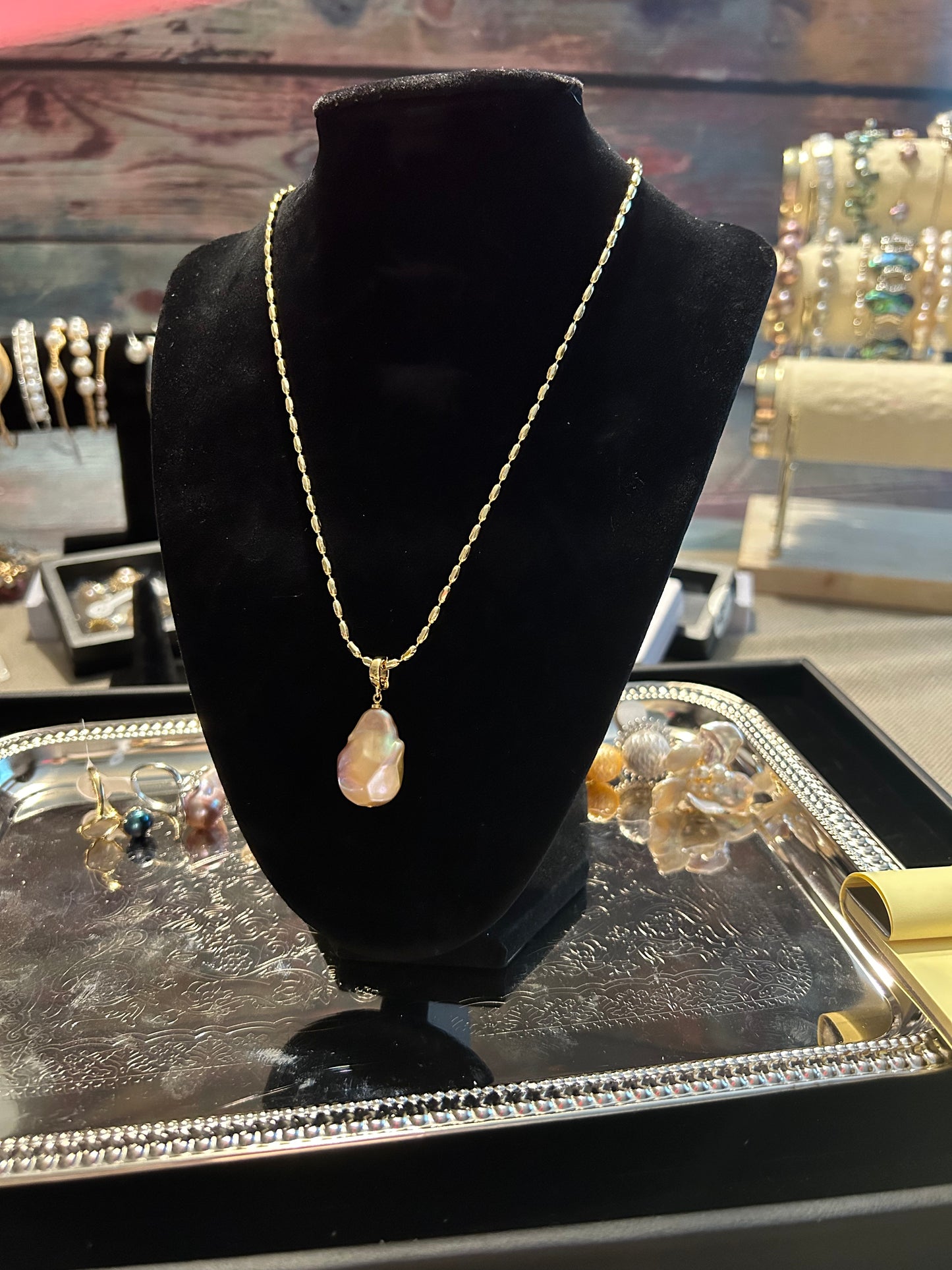 Single large baroque pearl on gold chain necklace